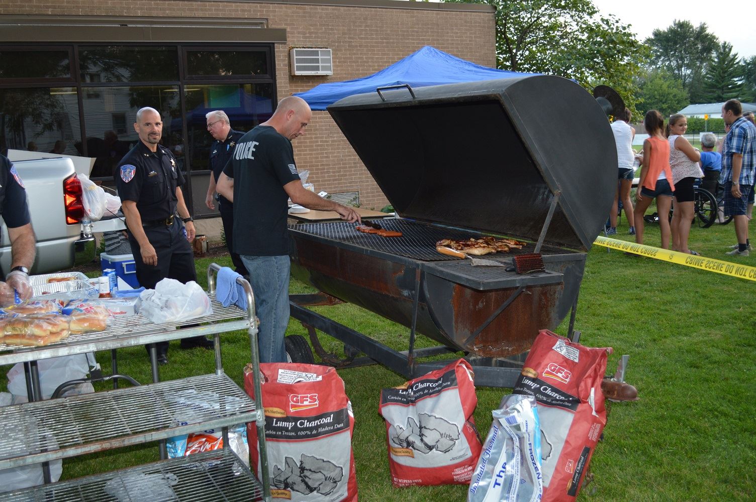 Villa Park Detective Hruby grills up food for community members at a National Night Out event at the Iowa Community Center, Aug. 2.